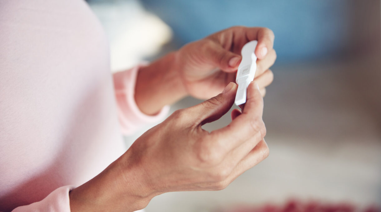 Woman hold pregnancy test stick